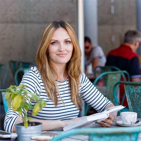 Woman Drinking Coffee And Reading Book In Cafe Stock Photo Image Of