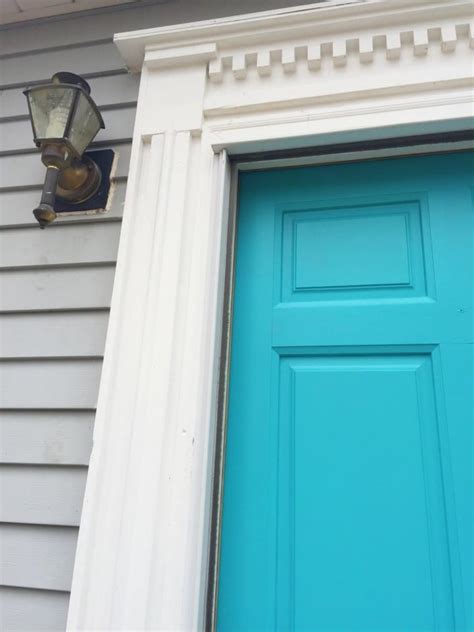 Porch with turquoise door and windows. Gray House No Shutters Turquoise Door - white house black shutters