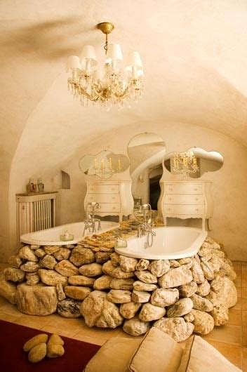 Stand alone bathtub, natural stone floor tiles, shower enclosed in stone tiles, beautiful stone walls all work together to create an amazing ambient in this spa like bathroom. 35 Amazing Raw Stone Bathroom Design Ideas - DigsDigs