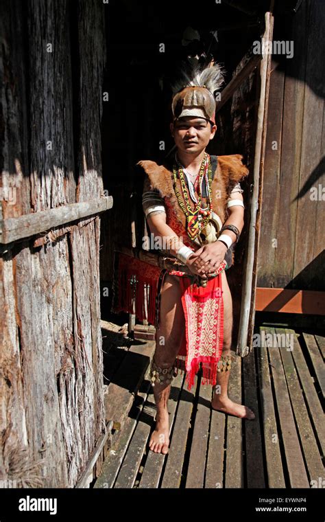 Man In Traditional Native Iban Costume In A Longhouse In Borneo