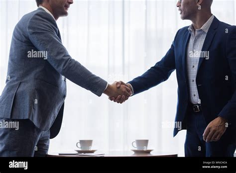 Two Business Men Shaking Hands With Each Other After A Deal