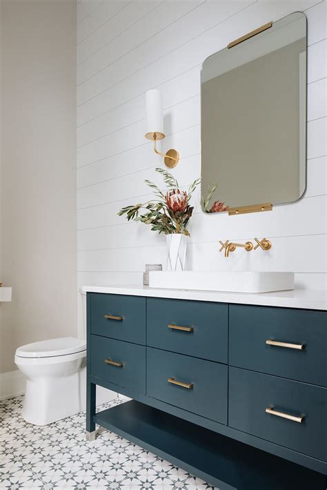 Bathroom cabinet vanity with marble worktop. teal vanity + square mirror + brass accents + freestanding ...