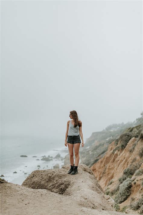 Woman Standing On Cliff Outdoors At The Beach By Stocksy Contributor Mango Street Lab Stocksy