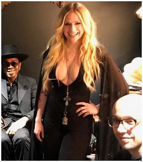 avril lavigne returns with a massive braless cleavage show… wow