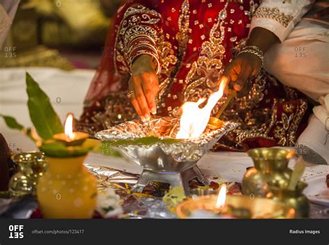 bride and groom performing fire ritual at hindu wedding ceremony toronto ontario canada stock
