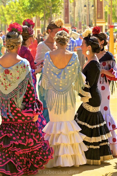 Spanish Girls In Traditional Dress Walking At The Seville Fair Stock