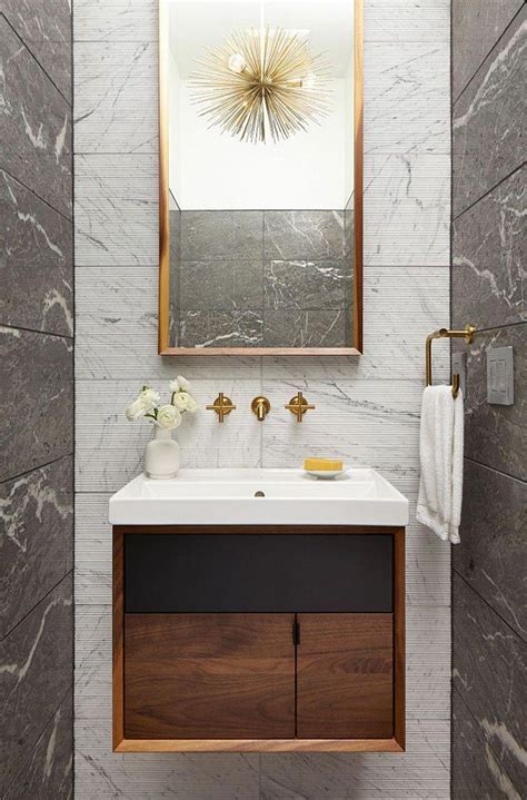 In This Modern Powder Room A Few Brass Accents And A Tall Mirror