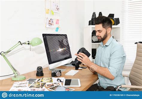 Professional Photographer With Camera Working At Table Stock Image