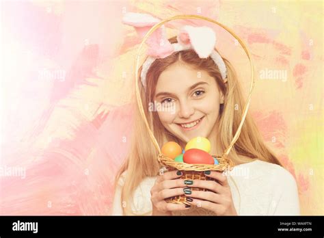Happy Easter Girl In Pink Bunny Ears With Colorful Painted Eggs In