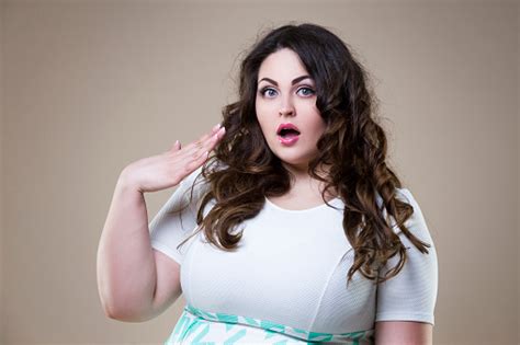 surprised plus size fashion model fat emotional woman on beige background overweight female body