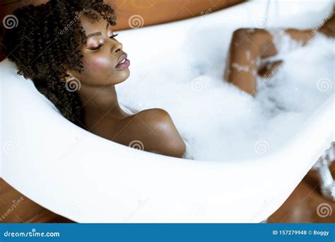 Beautiful African American Woman Bathing In A Tub Full Of Foam Stock