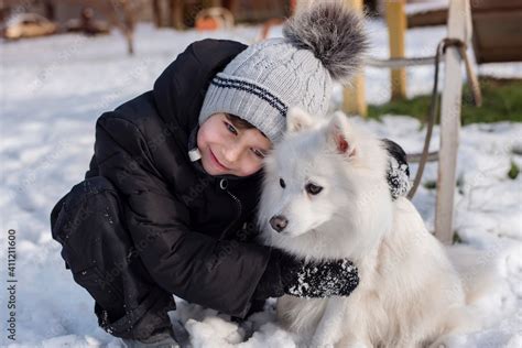Portrait Of A Young Boy Hugging His Favorite Japanese Spitz Dog A Boy