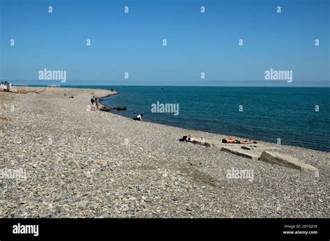 Beach Goers Sunbathe And Relax At Rocky Black Sea Shore Coastline Batumi Georgia Stock Photo Alamy
