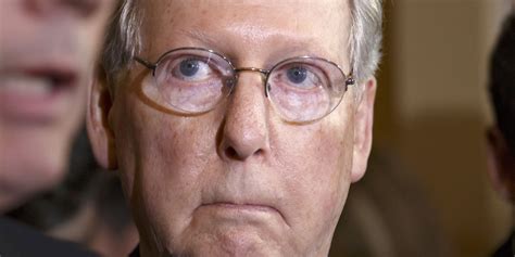 A tightly cropped photograph of discolored, purplish hands bearing a few small bandages, limply hanging from the sleeves of a black suit. Mitch McConnell Pulls Out The 'I'm Not A Scientist' Dodge ...