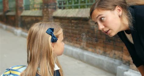 Close Up Of Angry Mother Scolding On Her Little Daughter At Street