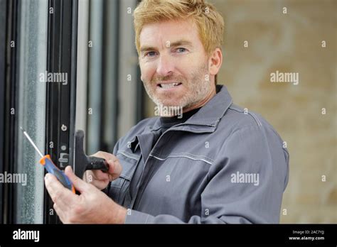 window and door glazing installer at work Stock Photo - Alamy