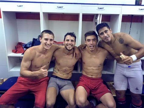 Four Shirtless Men Are Posing For A Photo In The Locker Room With Their Arms Around Each Other
