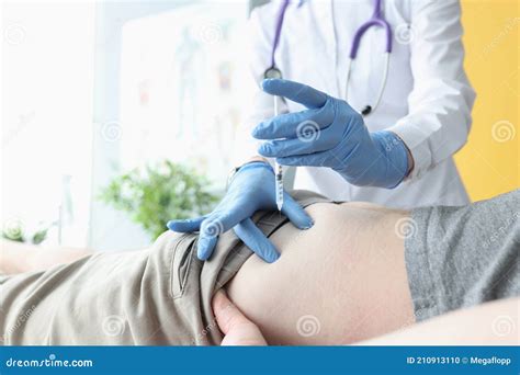 Nurse Giving Intramuscular Injection Of Medicine Into Patients Buttock Stock Photo