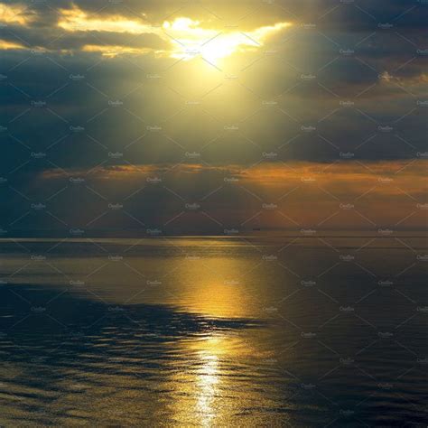 Bright Sun In Black Clouds Over Ocea Stock Photo Containing Sunset And