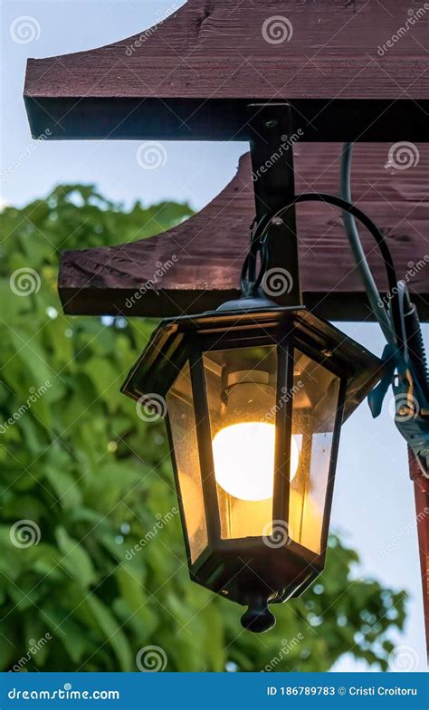 Vintage Street Lamp Or Lamp Post Hanging In Front Of A Red Brick Wall