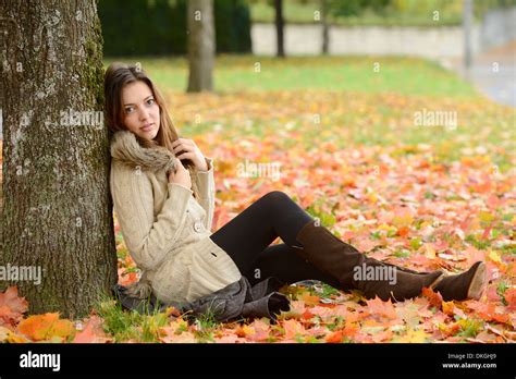 Woman Sitting Against Tree Trunk Hi Res Stock Photography And Images