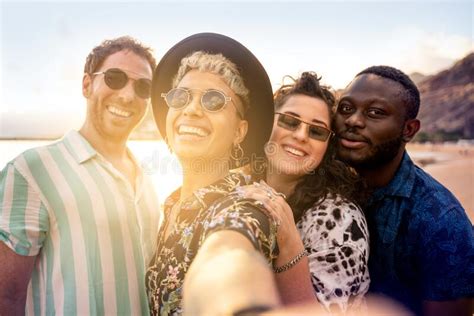 Group Of Multiracial Happy Young Friends Laughing Taking Selfie With
