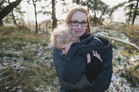 Young Pretty Mom Sunggling With Cute Son Outside In Winter Consoling