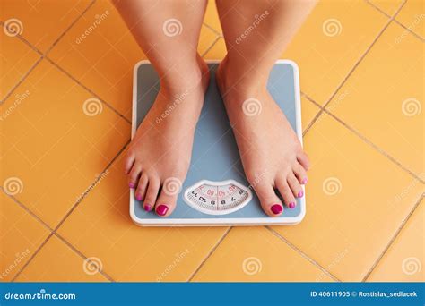 a pair of female feet on a bathroom scale stock image image of loss diet 40611905