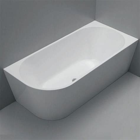 A White Bath Tub Sitting On Top Of A Gray Floor