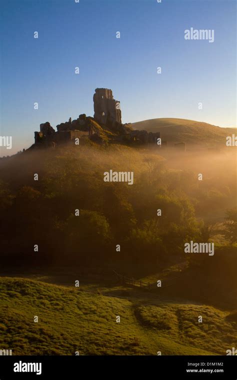 Corfe Castle At Dawn On A Misty Autumnal Morning Dorset England Uk