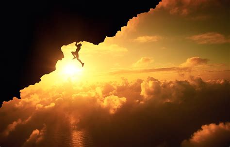 Silhouette Of Man Climbing Mountain With Cloudy Skies Landscape Sun
