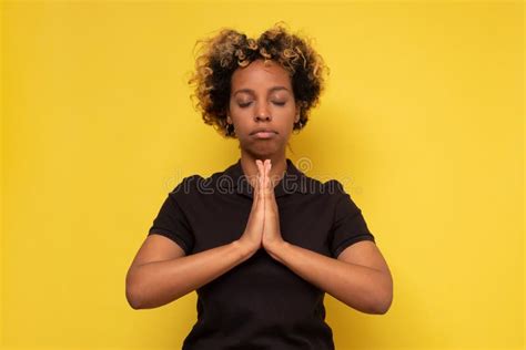 Young Black Woman Stands In Meditative Pose Enjoys Peaceful Atmosphere