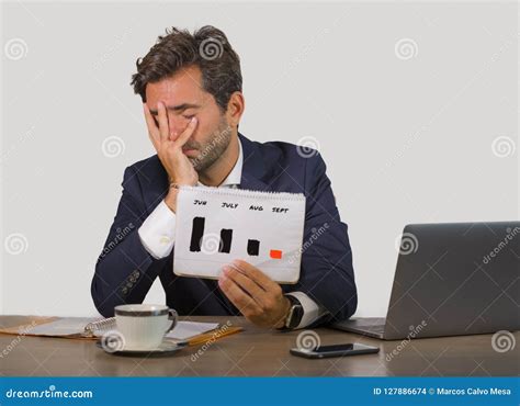 Young Attractive Sad And Depressed Businessman Working In Stress At