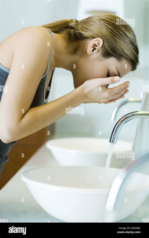 Woman Washing Face Over Sink Side View Stock Photo Alamy