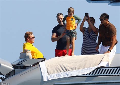 sir elton john soaks up the sun with husband david furnish and their sons aboard his luxury