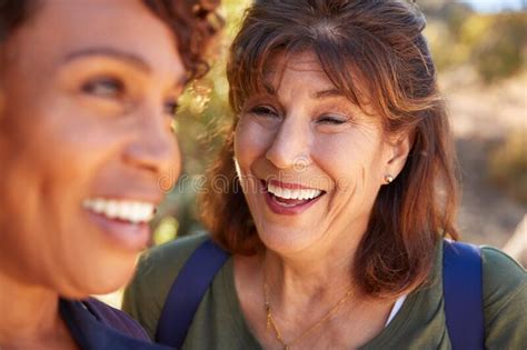 Portrait Of Loving Senior Hispanic Couple Hiking Along Trail In