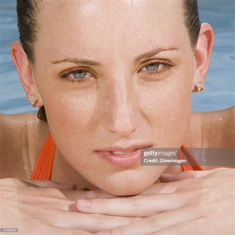 Portrait Of A Young Woman Leaning At The Edge Of A Swimming Pool High