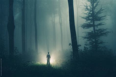 Alien In Dark Mysterious Forest With Strange Light By Stocksy