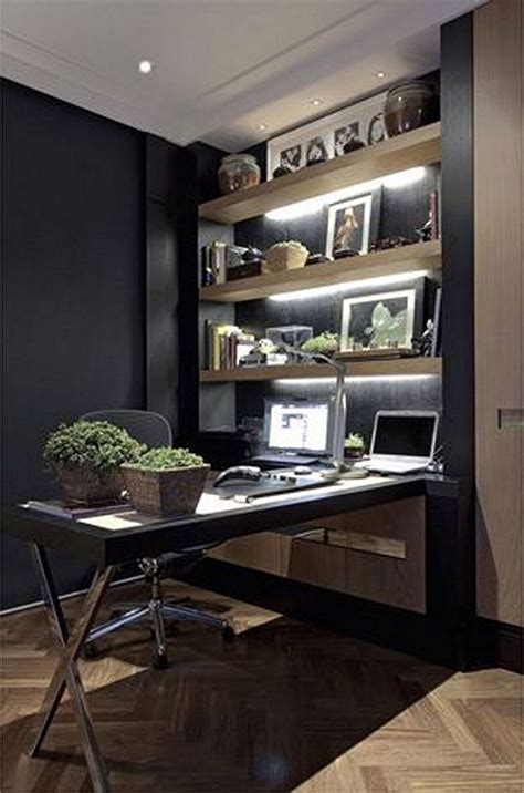 A Home Office With Black Walls And Wooden Flooring Built In Shelving Units