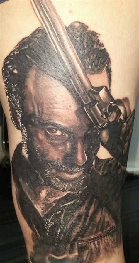 What you see is rick, holding a defeated zombie's head. Rick Grimes tattoo