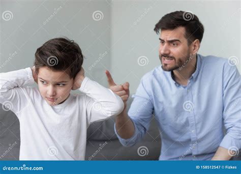 Angry Father Shouting At Stubborn Fussy Little Son Closing Ears Stock