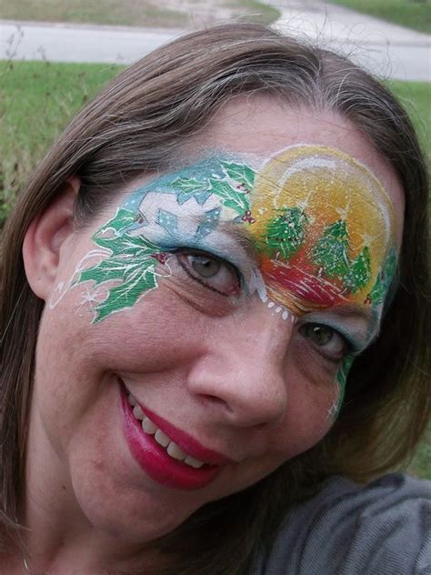 A Woman With Her Face Painted Like A Christmas Tree And Pineapples On It
