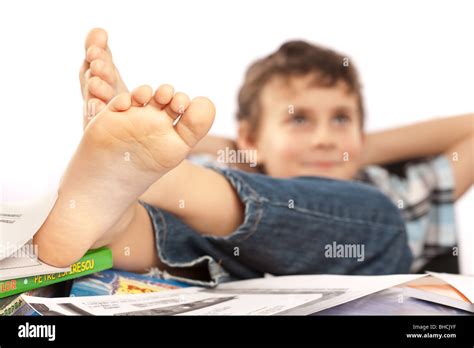 Portrait Of A Barefoot Schoolboy With His Feet Up On His Desk Waiting