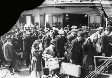 Immigrants Arriving At Ellis Island By Bettmann