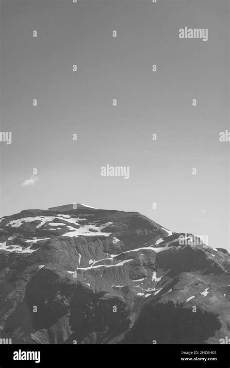 Vertical Grayscale Shot Of Snowy Mountain Peaks Stock Photo Alamy