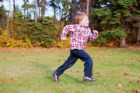 Young Boy Running In A Park In Autumnedmonton Alberta Canada Stock