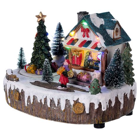 Soon, setting up illuminated villages with those little cardboard houses was a tradition in north american homes from many cultural backgrounds. Christmas village set with moving shop lighted tree ...