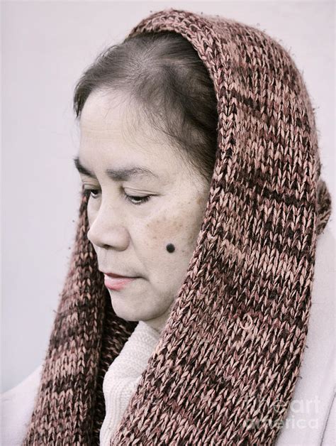 Portrait Of A Filipina With A Mole On Her Cheek And Wearing A Knitted