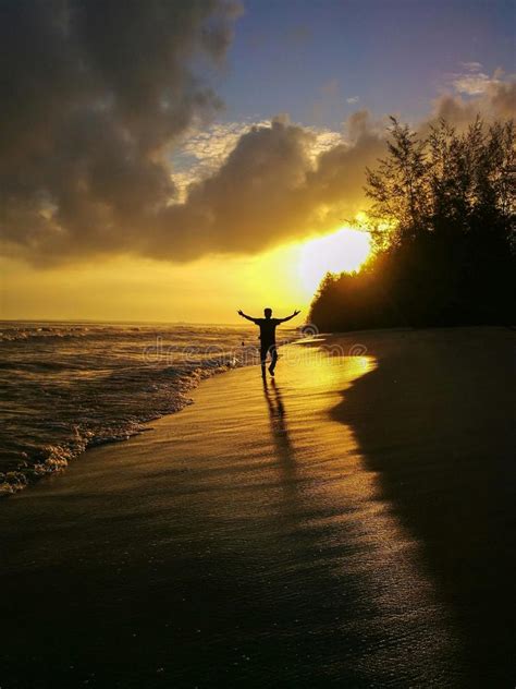 Person Walking On A Beach At Sunrise Stock Image Image Of Romance