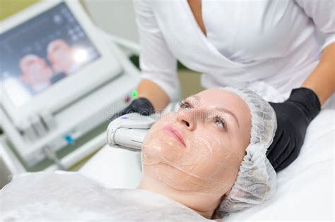 A Woman In A Cosmetology Office Receives A Smas Lifting Procedure Non Surgical Ultrasound